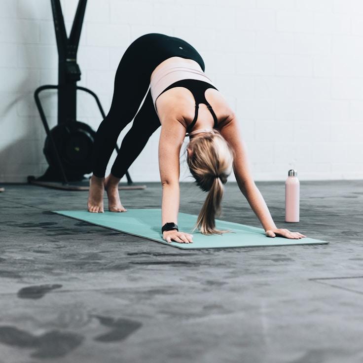 Women in a fitness class doing stretching and mobility exercises